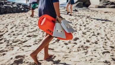 person carrying an orange rescue can