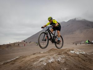 man riding a bike on a desert