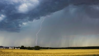 dramatic thunderstorm over farmland landscape